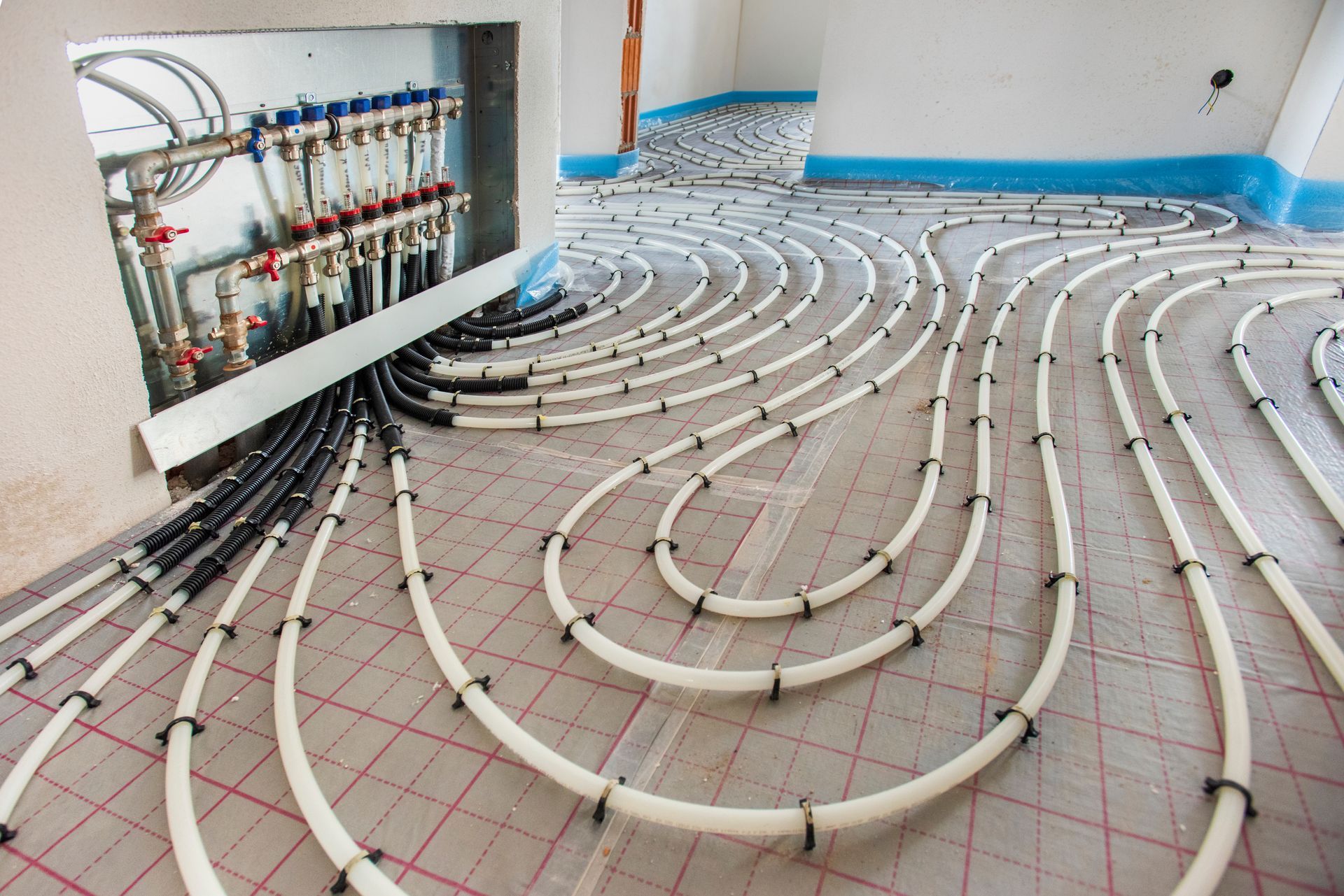 A room with a lot of pipes on the floor.