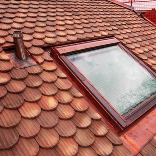 A wooden roof with a skylight in the middle