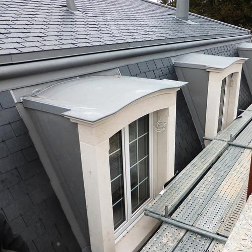 A window on the side of a building with a scaffolding in front of it.
