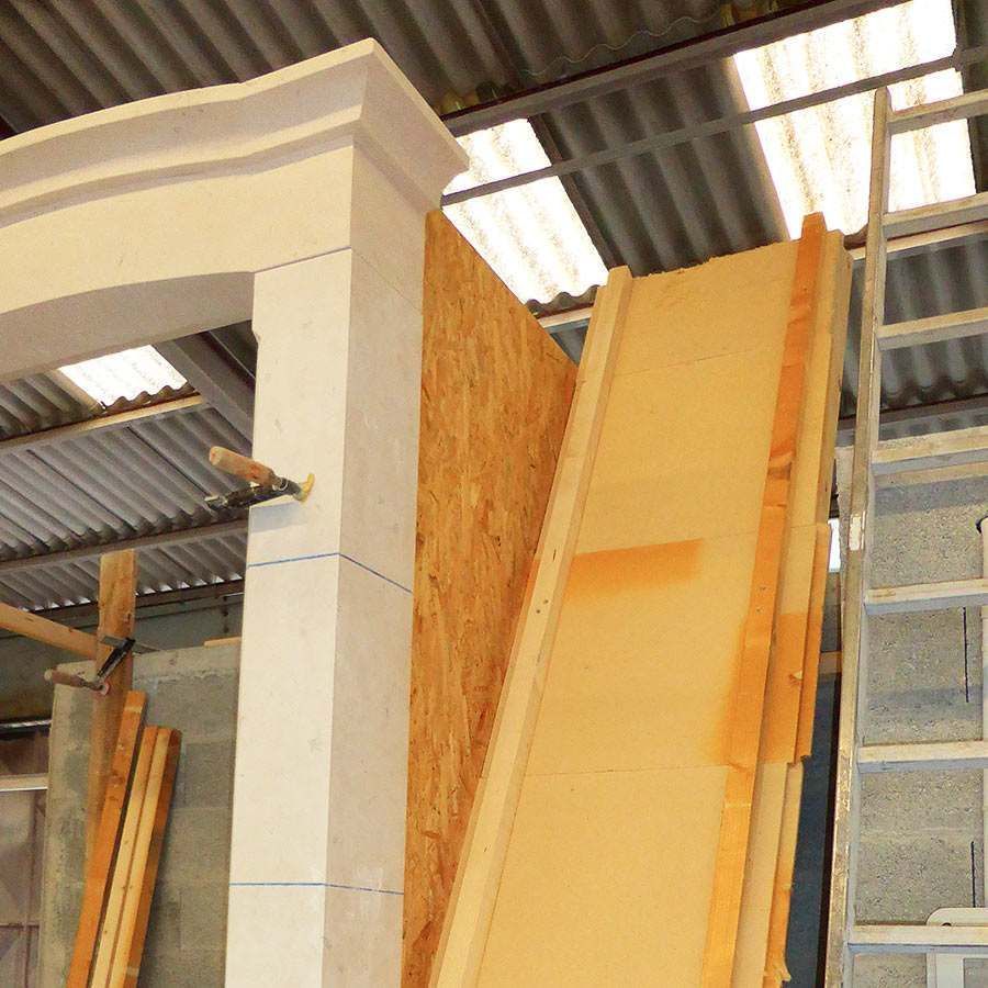 A wooden staircase is being built in a warehouse
