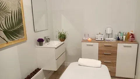Hay una mesa de masajes en el medio de la habitación.