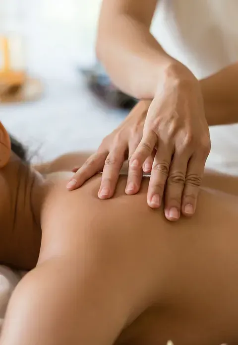 Una mujer está recibiendo un masaje en la espalda en un spa.
