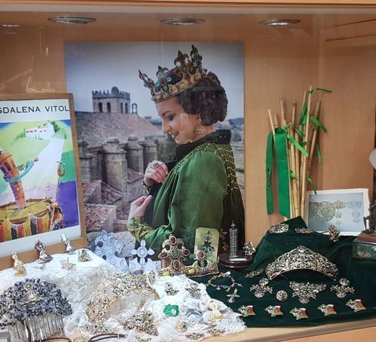 Una mujer con un vestido verde y una corona en la cabeza.