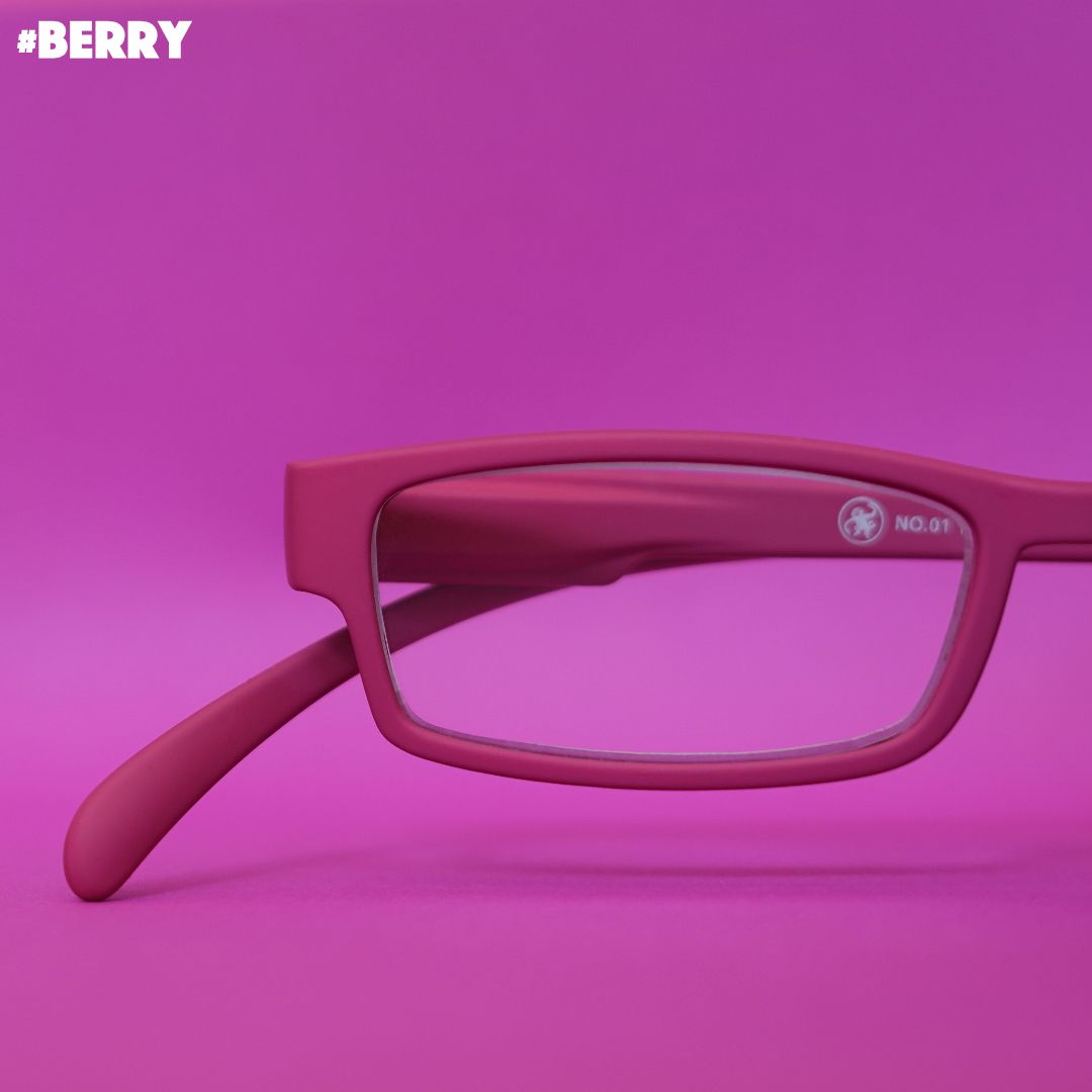 Eine Beeren farbene Lesebrille auf pinkem Hintergrund.