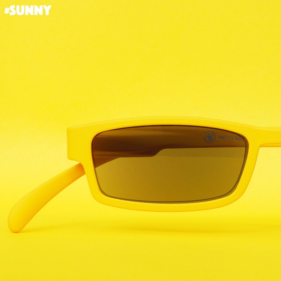 Eine gelbe Sonnenlesebrille auf gelbem Hintergrund