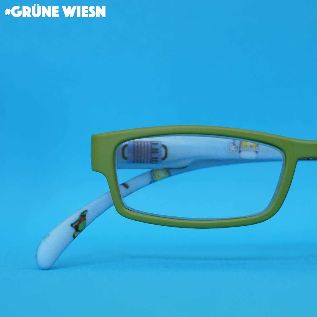 Eine Lesebrille mit grüner Front und blauen Bügeln im Wiesn Look auf blauem Hintergrund.
