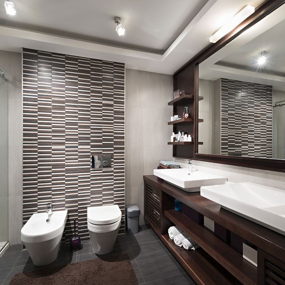 Ein Badezimmer mit zwei Toiletten, einem Bidet und einem Waschbecken