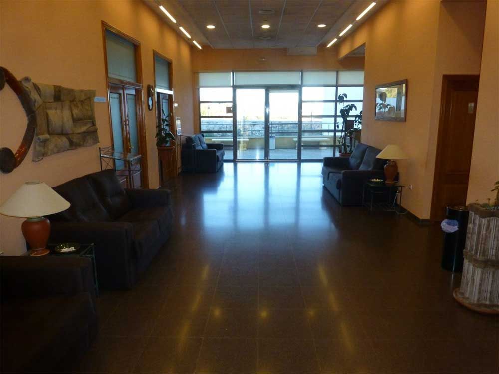 Un largo pasillo con muchos muebles y lámparas.