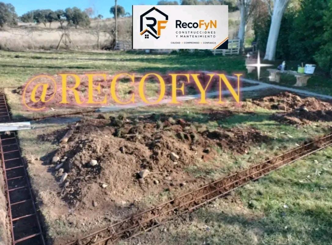 Excavación en el patio trasero con tierra y ladrillos al descubierto, y un letrero de RecoFYN al fondo.