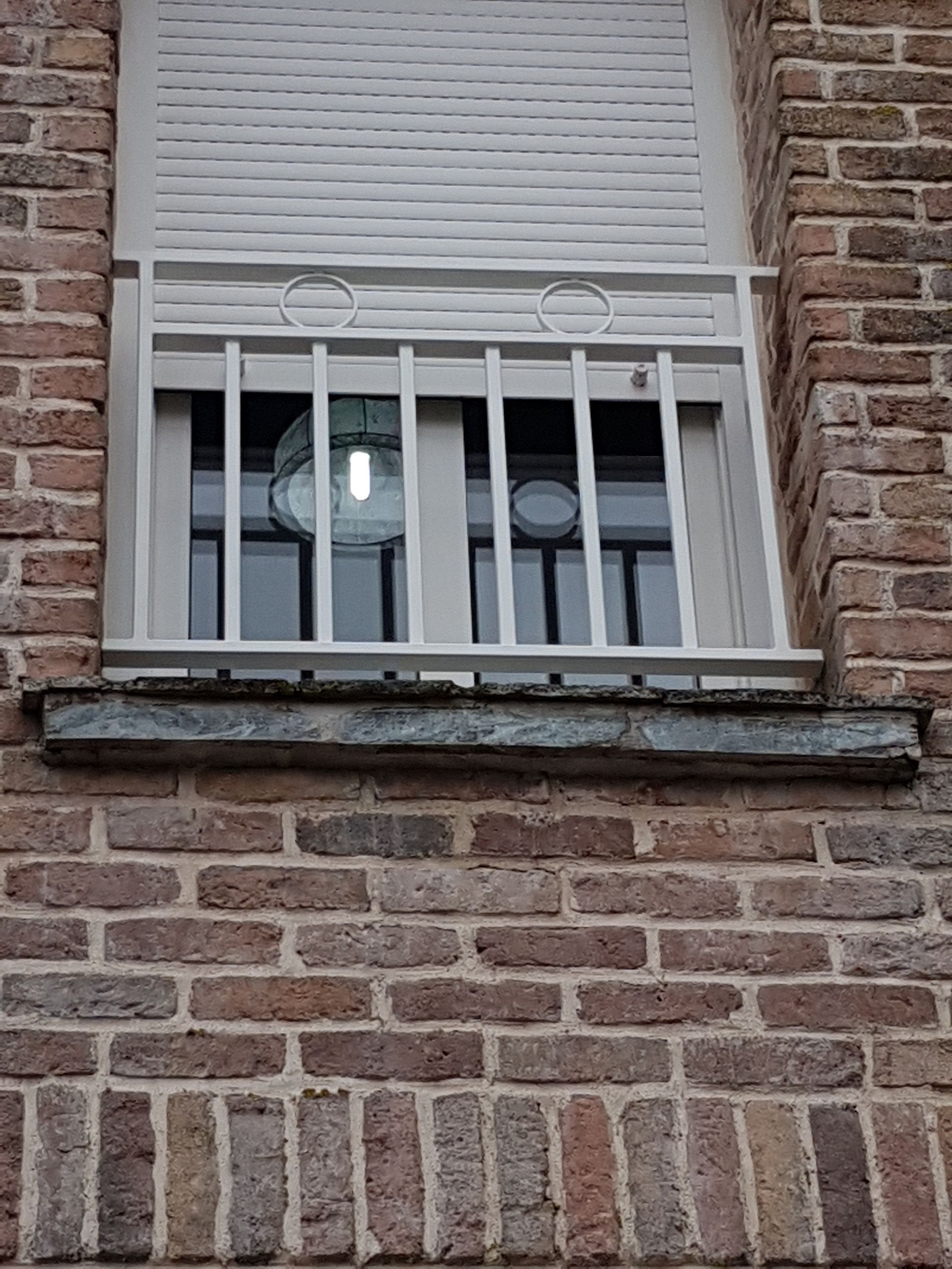 Grille de défense blanche sur une fenêtre