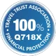 Blue circular Travel Trust Association financial protection badge with “100%” and code “Q718X”