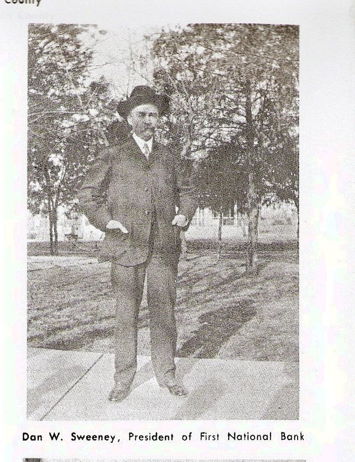 A black and white photo of a man in a suit and hat