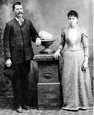 A black and white photo of a man and woman standing next to each other