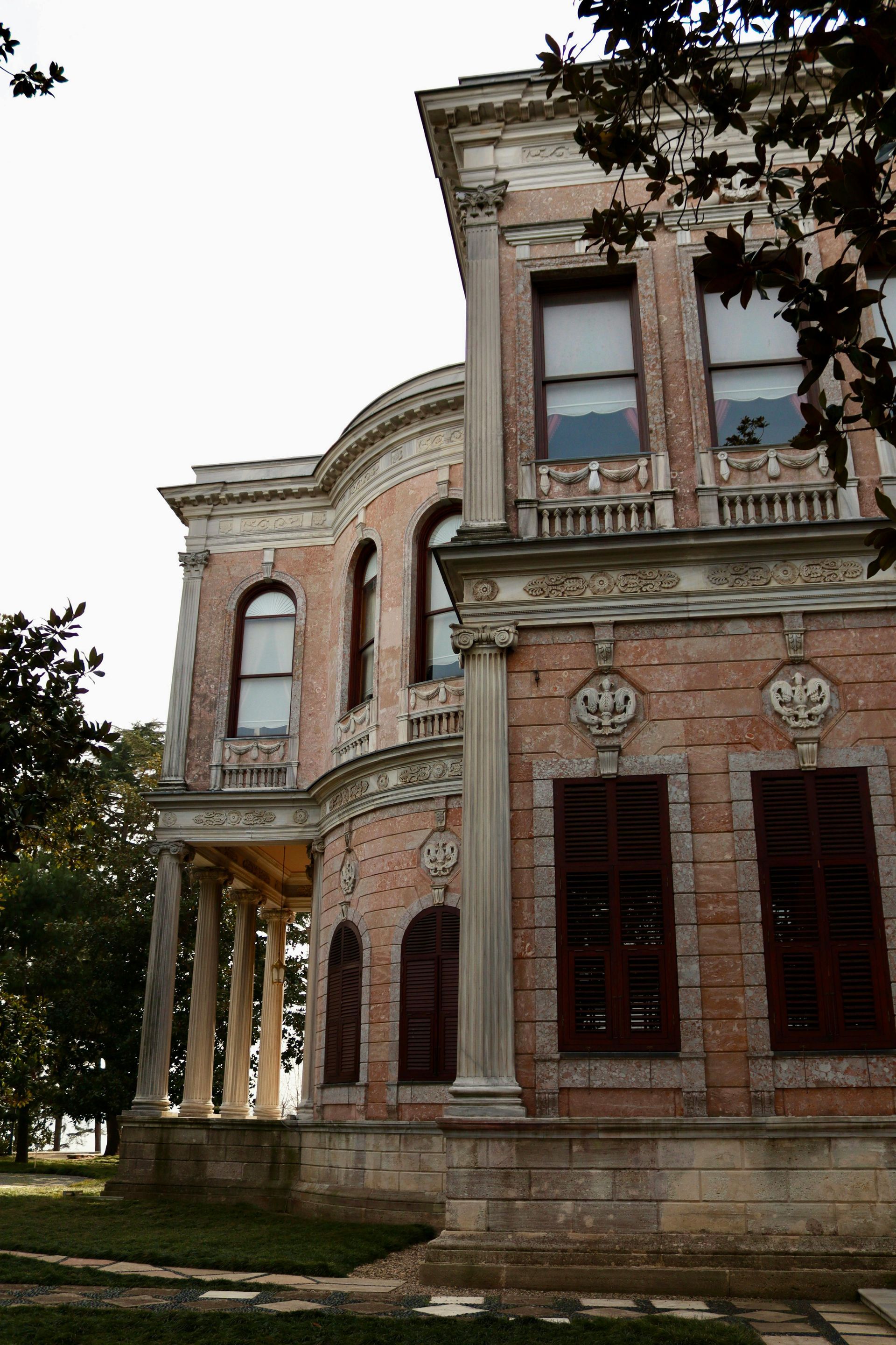 A large brick building with a lot of windows and columns