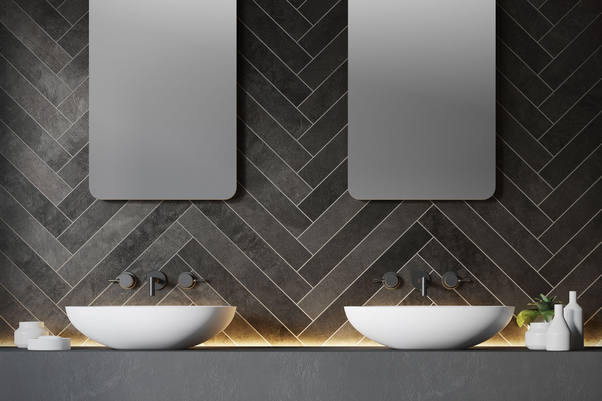 Une salle de bains moderne avec deux vasques blanches, des robinets muraux et des miroirs rectangulaires sur un carrelage foncé à chevrons.