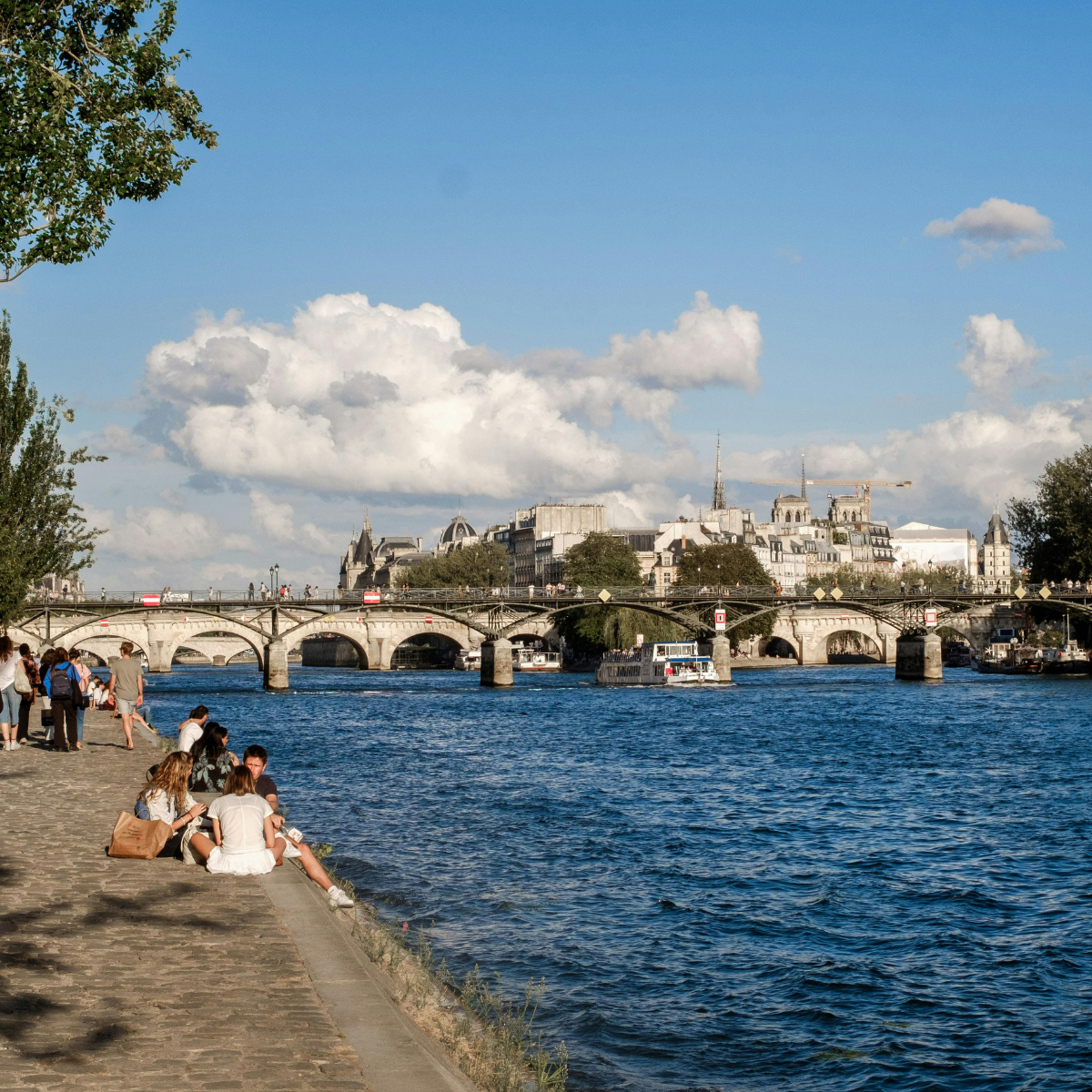 Desk with map, computer screen displaying map, coffee mug, succulent, and window view.