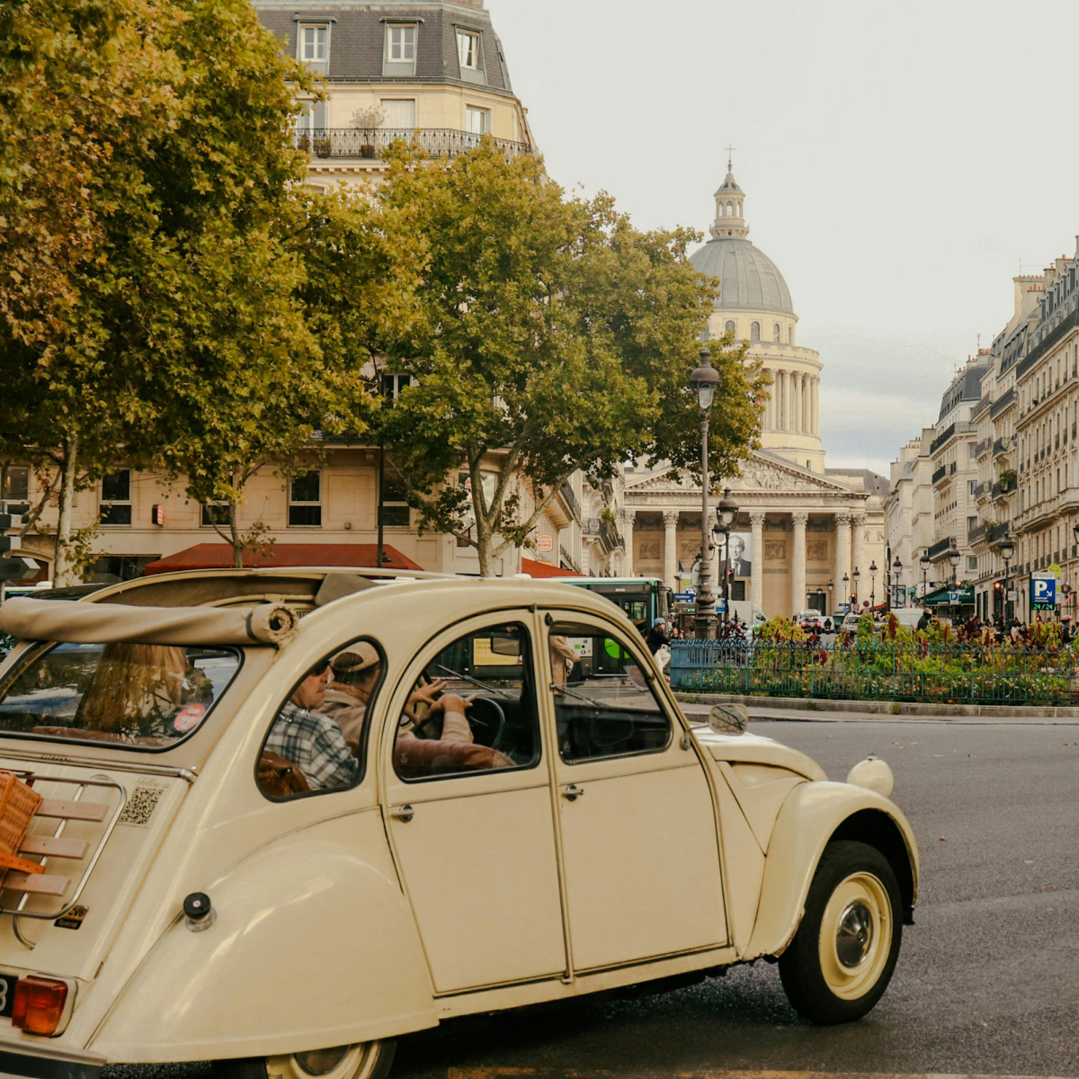Desk with map, computer screen displaying map, coffee mug, succulent, and window view.