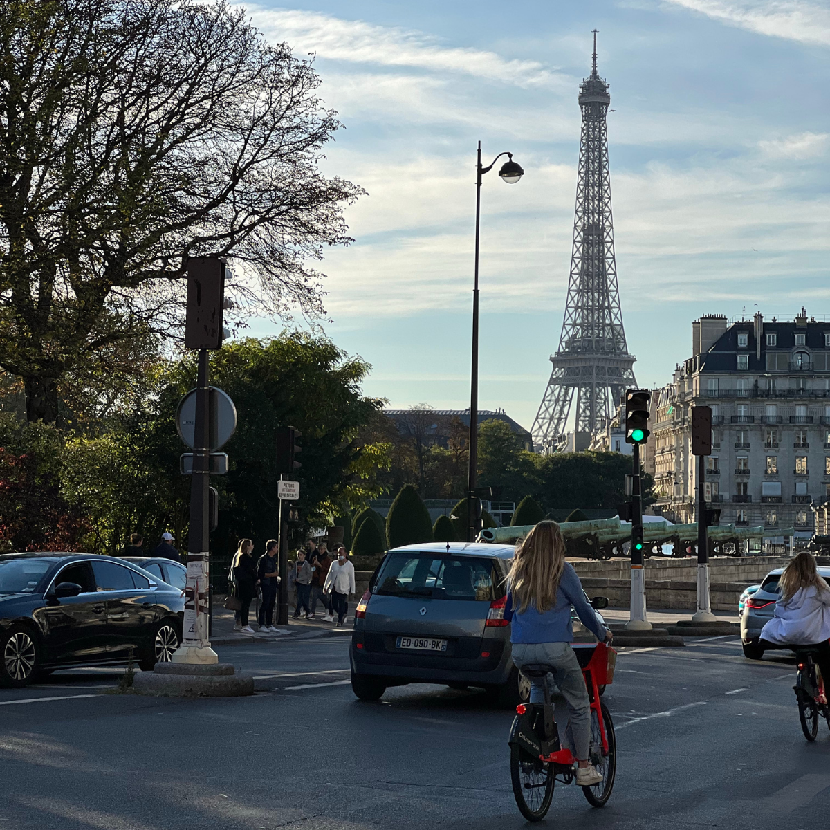 Desk with map, computer screen displaying map, coffee mug, succulent, and window view.