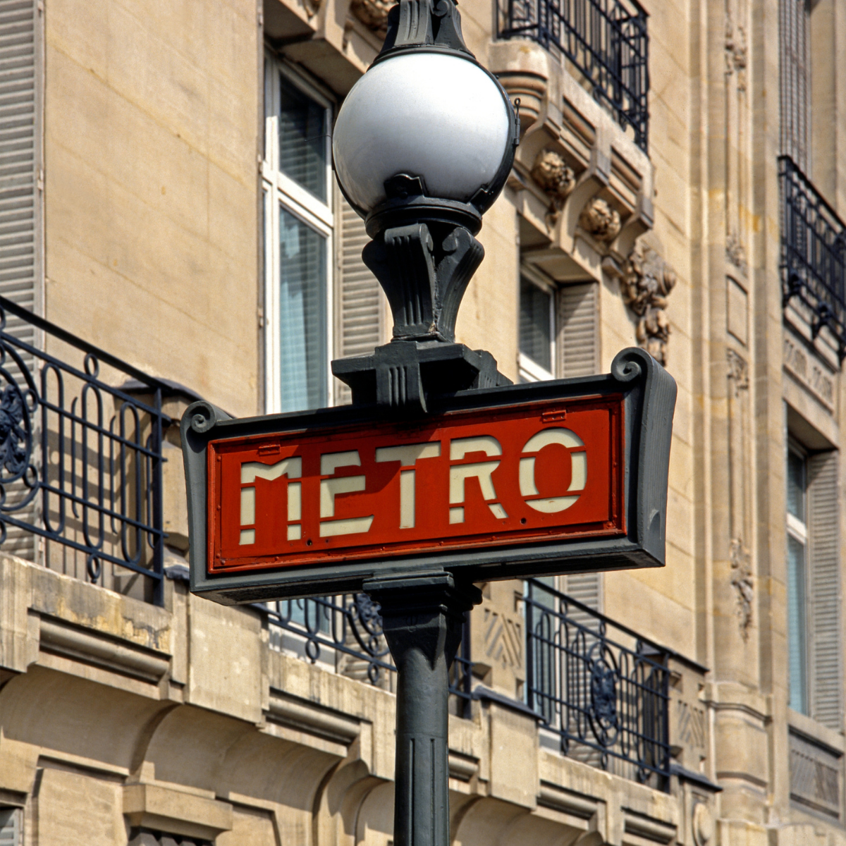Desk with map, computer screen displaying map, coffee mug, succulent, and window view.