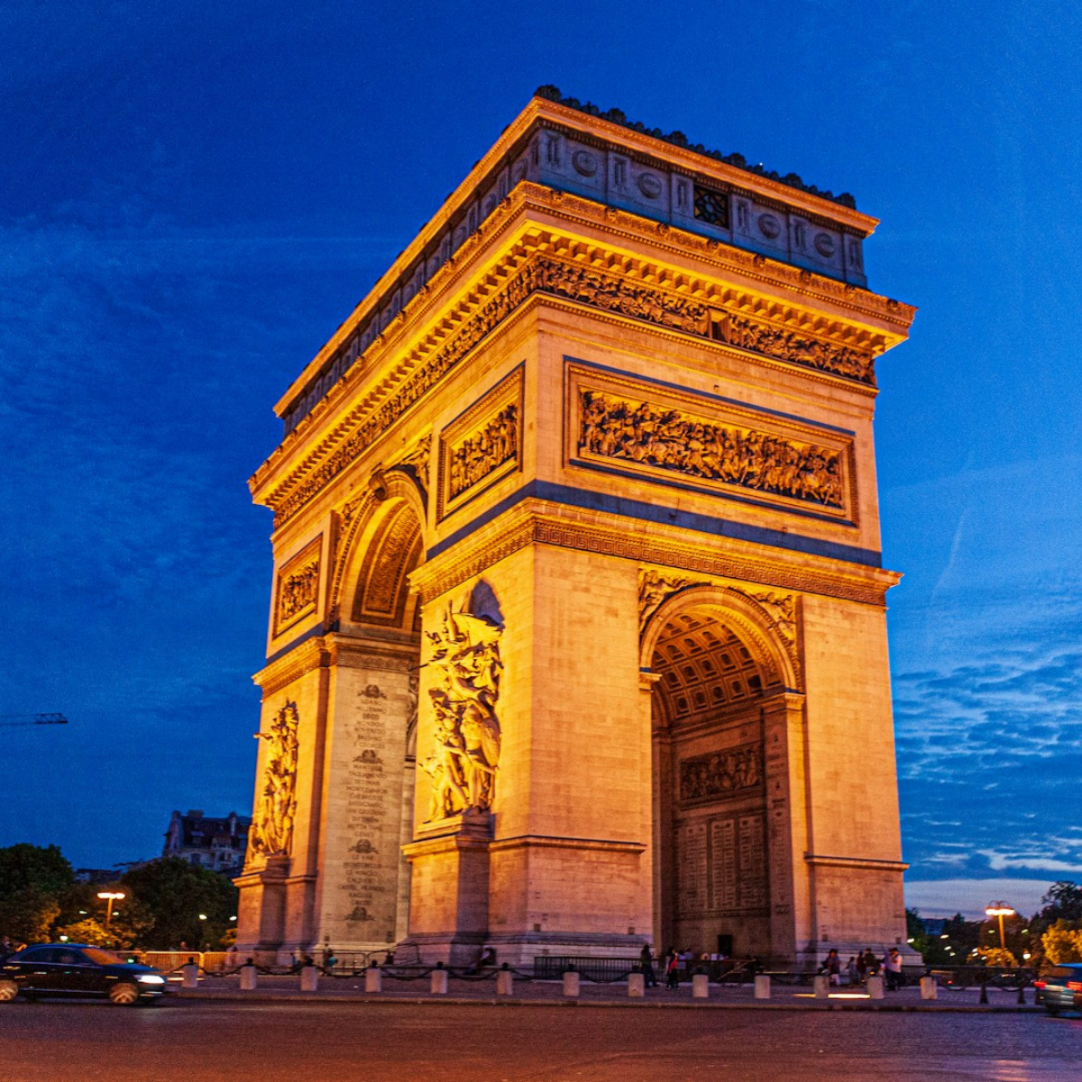 Woman wearing headset at desk with computer, Eiffel Tower art in background.