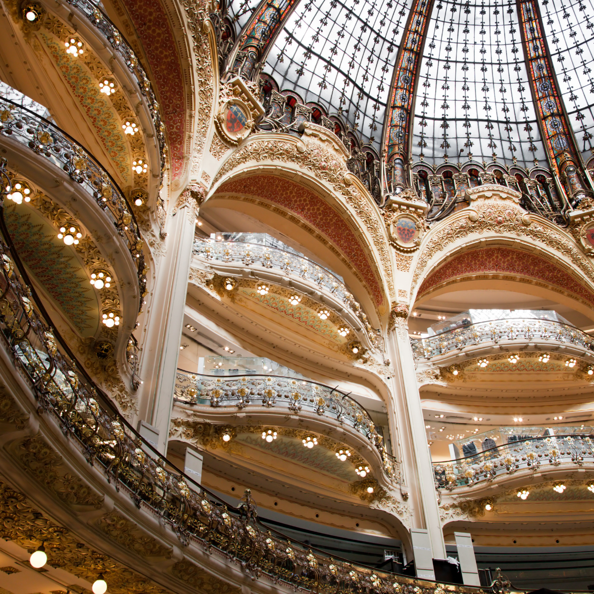 Desk with map, computer screen displaying map, coffee mug, succulent, and window view.