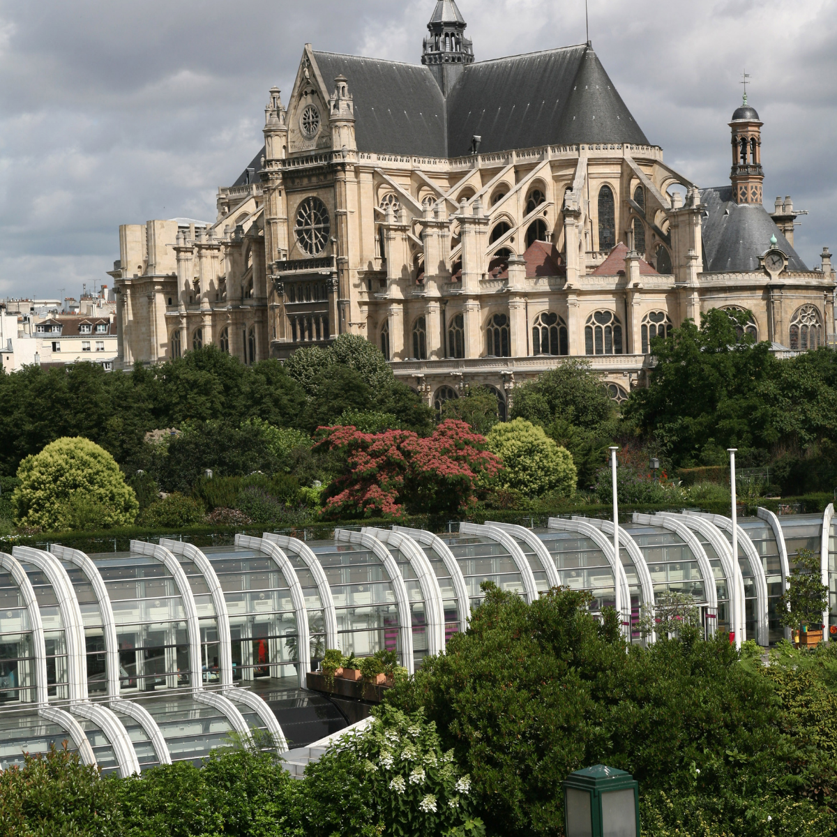 Woman wearing headset at desk with computer, Eiffel Tower art in background.