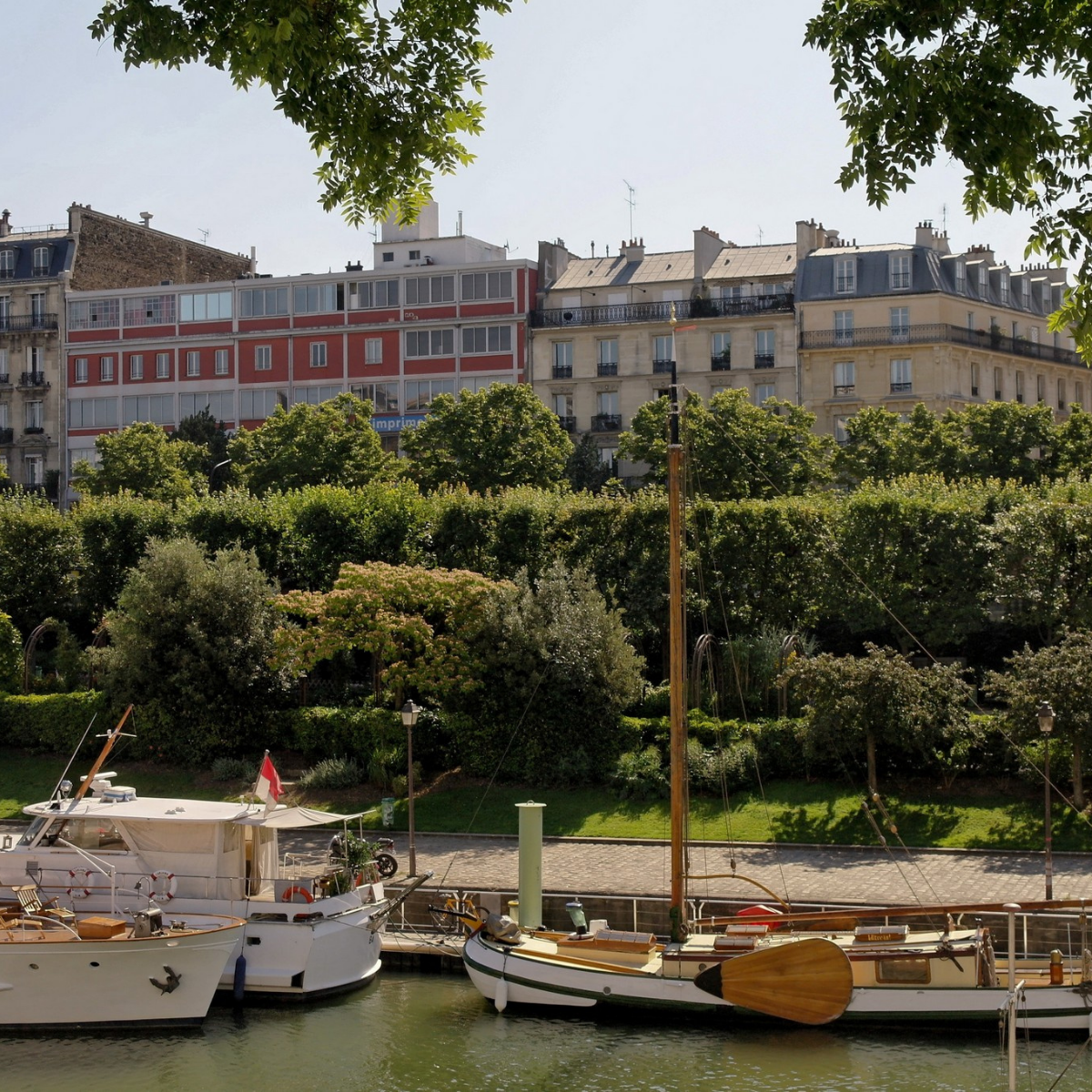 Desk with map, computer screen displaying map, coffee mug, succulent, and window view.