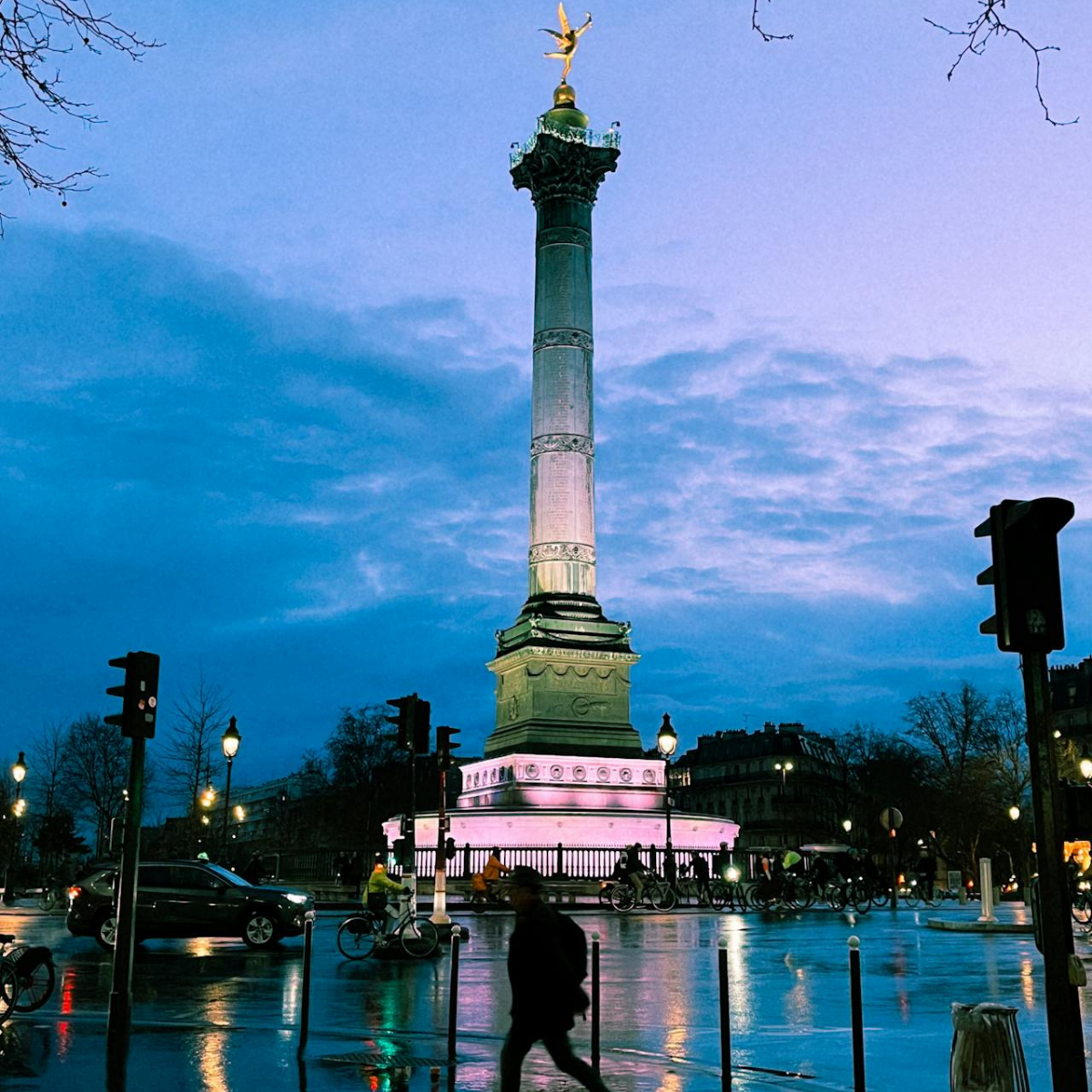 Woman wearing headset at desk with computer, Eiffel Tower art in background.