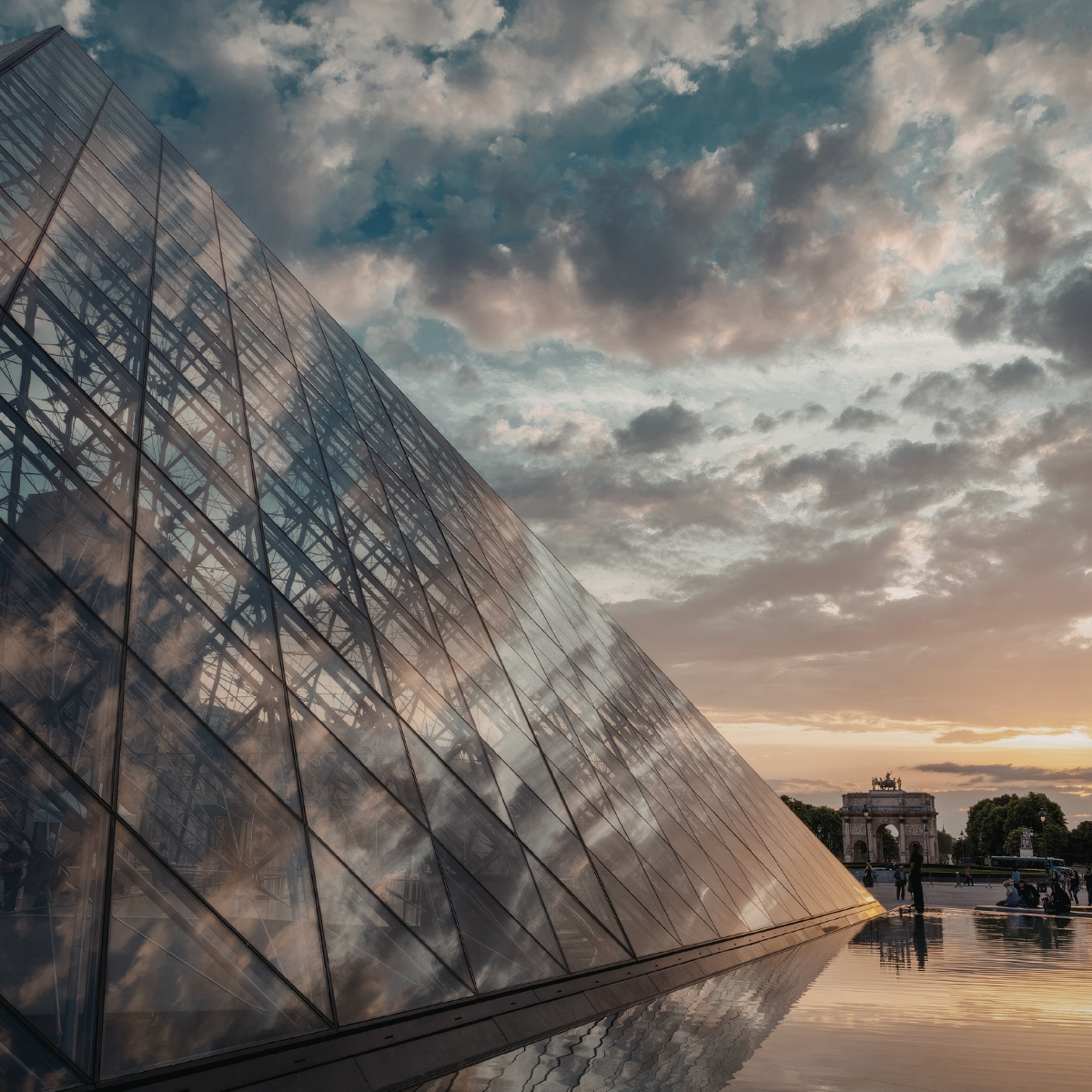 Desk with map, computer screen displaying map, coffee mug, succulent, and window view.