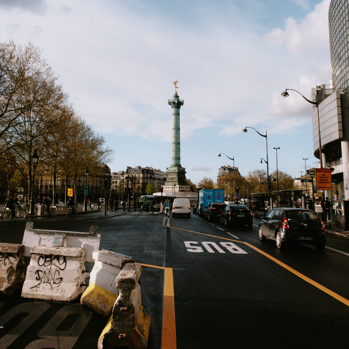 Desk with map, computer screen displaying map, coffee mug, succulent, and window view.