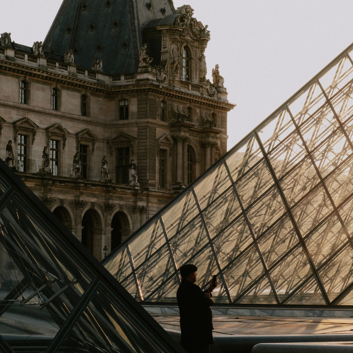 Desk with map, computer screen displaying map, coffee mug, succulent, and window view.