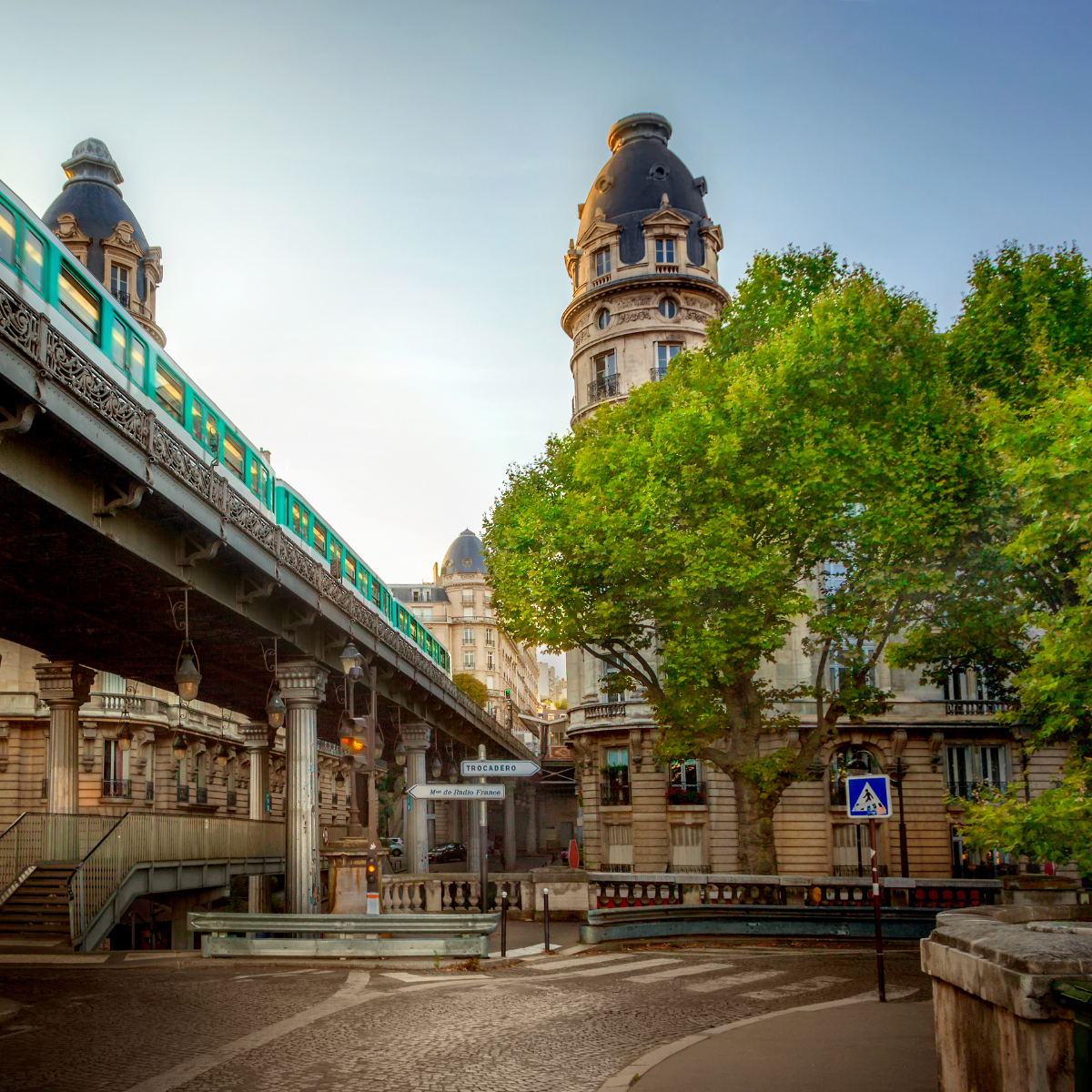 Desk with map, computer screen displaying map, coffee mug, succulent, and window view.