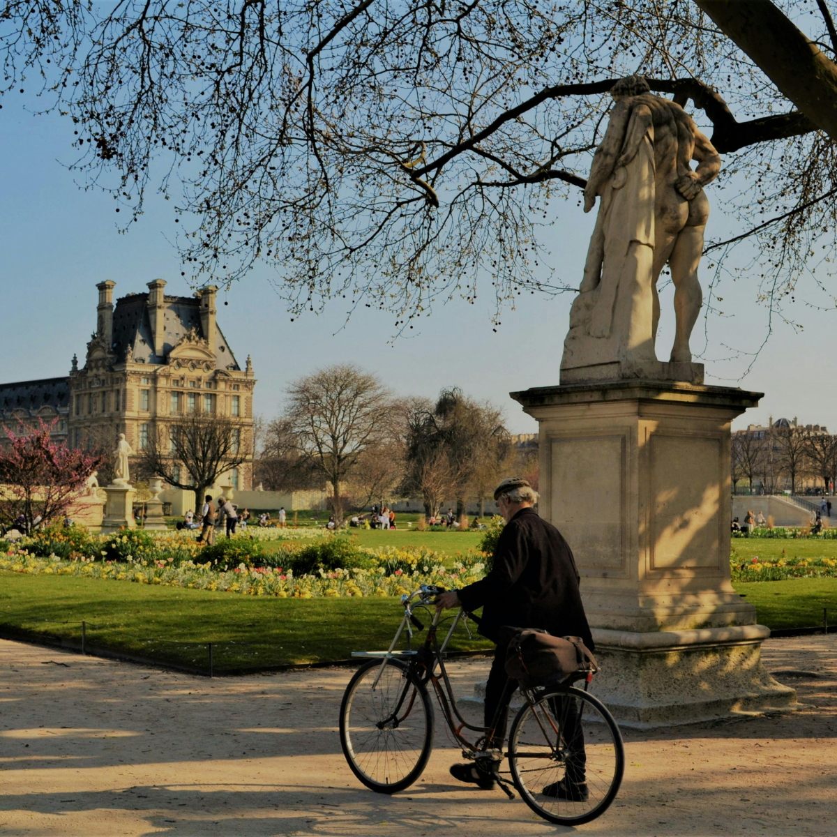 Woman wearing headset at desk with computer, Eiffel Tower art in background.