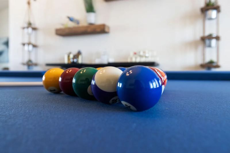 Pool balls racked on a blue felt table, ready to break.