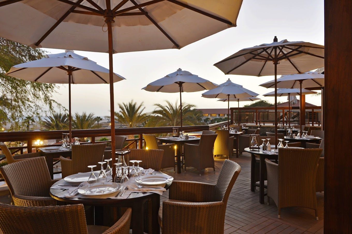 A restaurant with tables and chairs and umbrellas