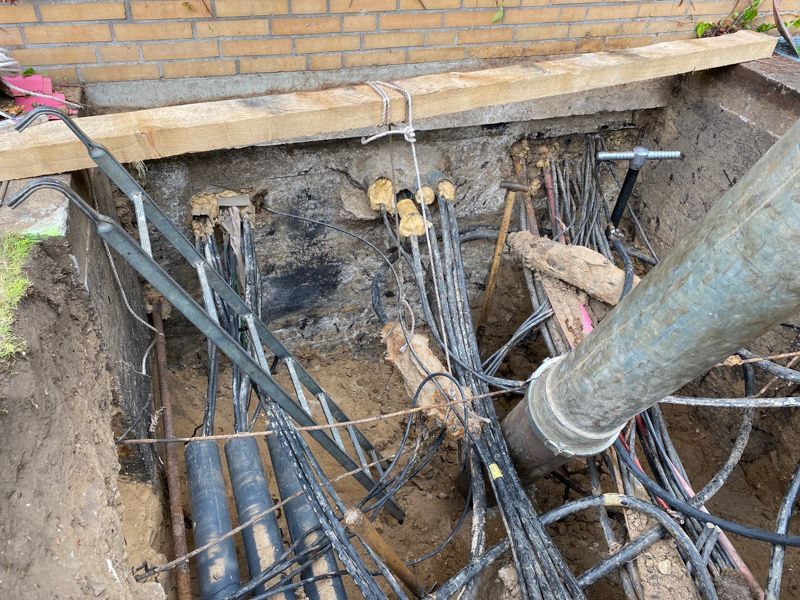 Ein Bündel Drähte liegt in einem Loch auf dem Boden.