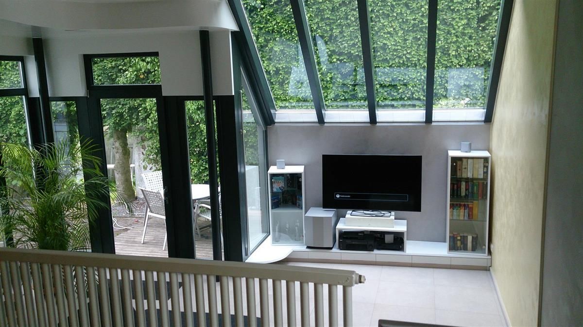 Ein Wohnzimmer mit einem Flachbildfernseher an der Wand