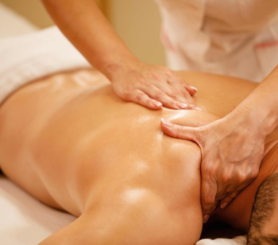Una persona recibe un relajante masaje facial profesional en un ambiente de spa sereno y con iluminación tenue.