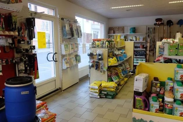 Intérieur d'une petite supérette avec des étagères remplies de produits pour  l'entretien de jardin