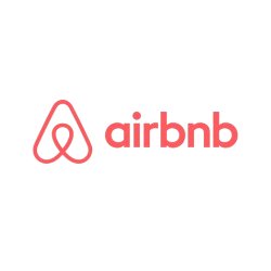 El logotipo de Airbnb es rojo sobre un fondo blanco.