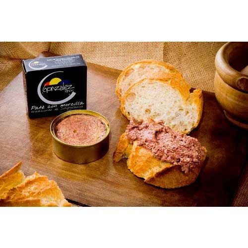 Hay un sándwich con carne encima en una mesa de madera.