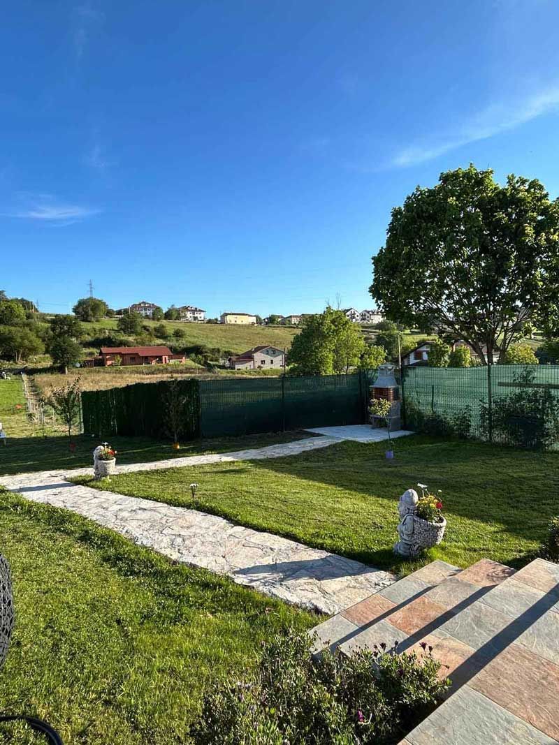 Hay un camino que atraviesa el césped del patio trasero.