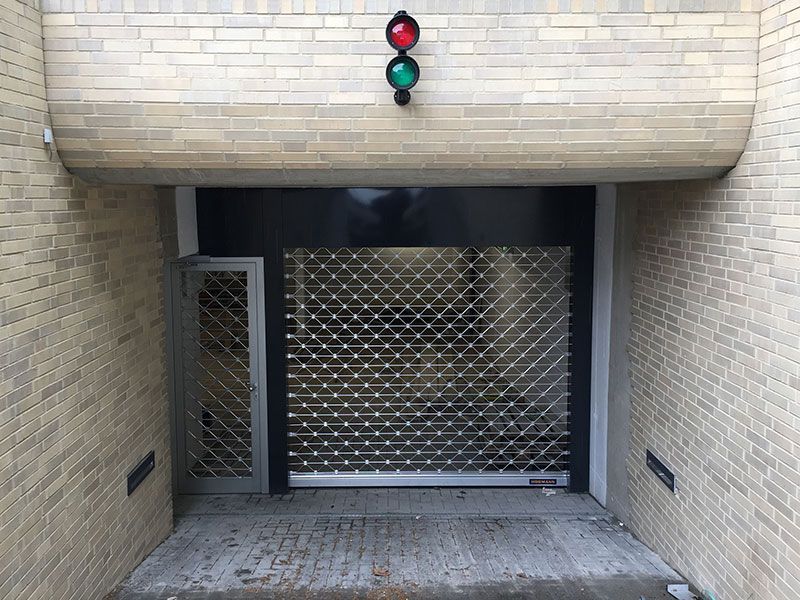 Ein Backsteingebäude mit einem Garagentor und einer Ampel darüber