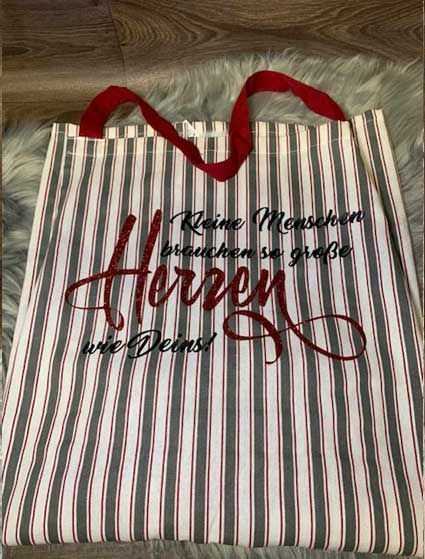 Eine gestreifte Einkaufstasche mit den Worten „Herzen“ darauf geschrieben