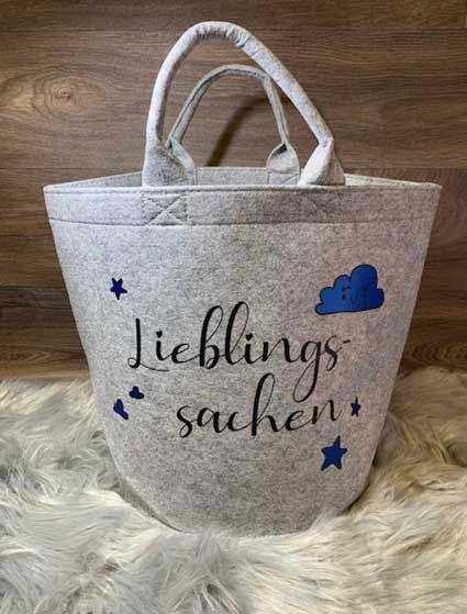 Eine weiße Einkaufstasche mit einer blauen Wolke und Sternen darauf.