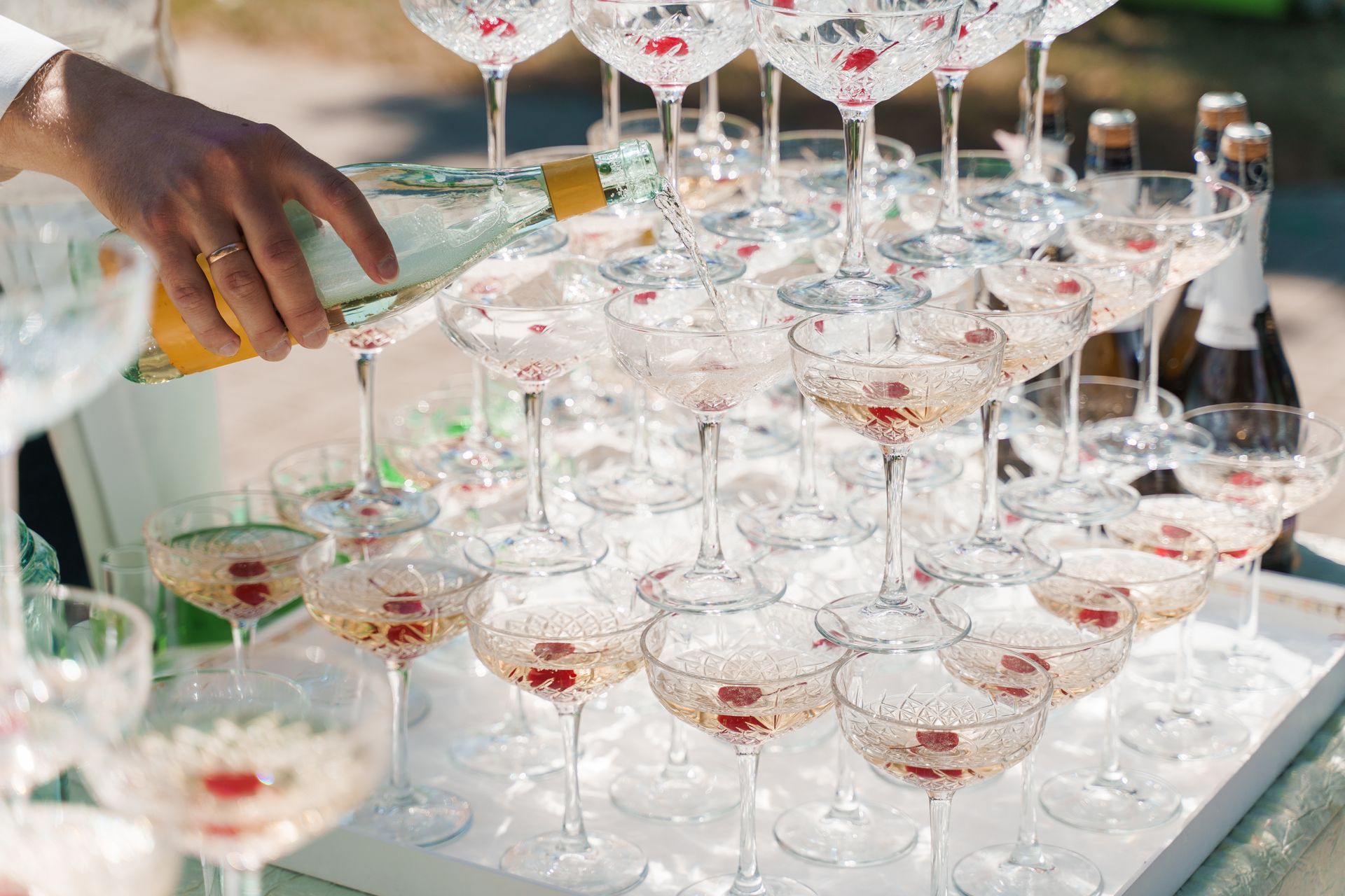 Empiler à la main des verres à cocktail sur un plateau miroir