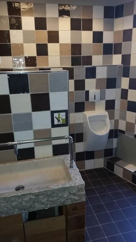 Ein Badezimmer mit karierten Fliesen und einem Urinal