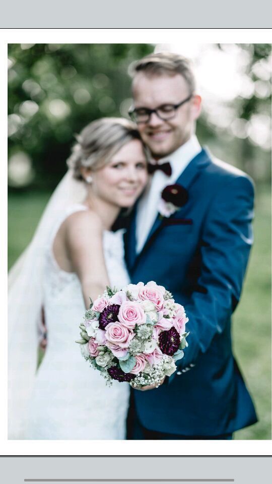 Hochzeitsfoto eines Paares, das eng beieinander steht und lächelt.