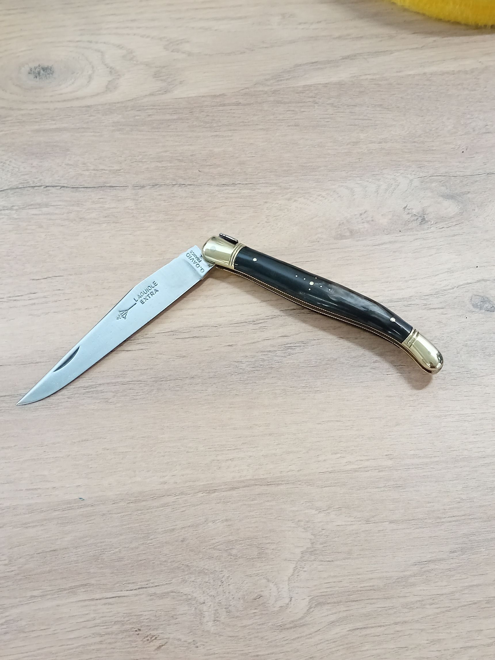 Petit couteau pliant Laguiole, manche couleur noir et lame en acier.