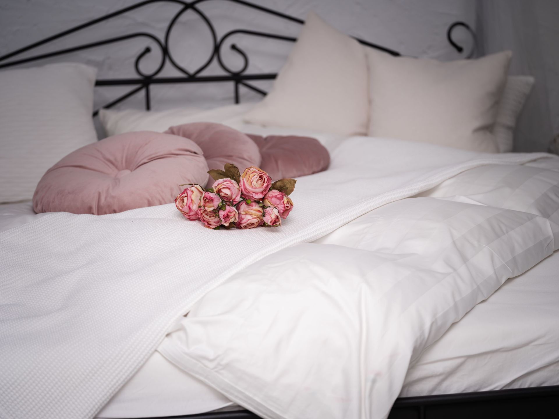 Sabine Olbertz - ein Bett, als Fotoshooting Ort mit roséfarbenen Deko-Kissen und Rosen